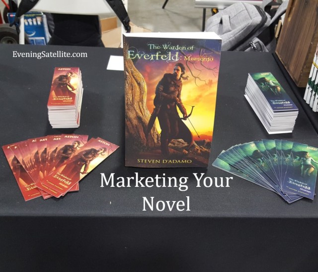 Title card for Marketing Your Novel, photo from AwesomeCon 2019 table, The Warden of Everfeld: Memento fantasy novel, Steve D'Adamo